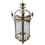 A BRASS FOUR LIGHT CENTRAL HALL LANTERN, the candle arms surrounded by curved etched glass panels,