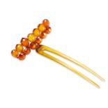 AN BEADED AMBER HAIR PIN Set with thirteen faceted beads hinged on a simple hair pin. One bead