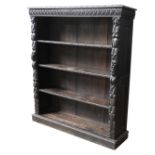 AN ORNATE CARVED OAK 19TH CENTURY BOOKCASE, with three adjustable shelves, a central lobe carved