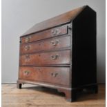 A GEORGIAN III OAK BUREAU, witha sloping fall above four graduated drawers, on bracket feet, the