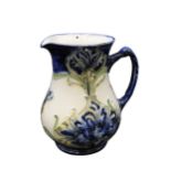 AN EARLY WILLIAM MOORCROFT FOR MACINTYRE FLORIAN WARE JUG, circa 1900, glazed in blue and green