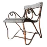 A WROUGHT-IRON WOODEN SLATTED WEATHERED GARDEN ARMCHAIR, with curved seat, back panel and scroll