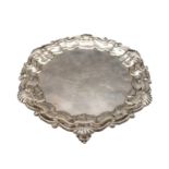 A SILVER SALVER, with acanthus shell-scroll border on three scroll feet, London 1916, maker's mark G