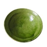 A GREEN GLAZED CONTINENTAL EARTHENWARE BOWL, 29 cm diameter