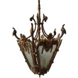 A BRASS HALL LANTERN WITH FIVE GLASS PANELS, AND CAST WITH GROTESQUES, 20t century, and a modern