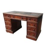 A VICTORIAN MAHOGANY LEATHER TOP WRITING DESK, the top section comprising of a long central frieze