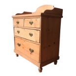 A VICTORIAN PINE GALLERY BACK CHEST OF FOUR DRAWERS, two short drawers over two long drawers, on