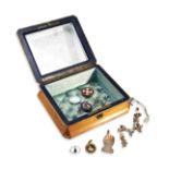 A COLLECTION OF JEWELLERY A three stone paste bar brooch. Two enamel coin brooches dating from 1887.