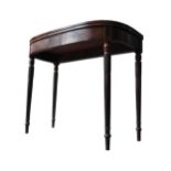 A REGENCY MAHOGANY CARD TABLE, the folding baize lined top supported by four reeded legs carved with