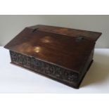 A CHARLES II CARVED OAK DESK BOX, with initials MW, 29 x 72 x 44 cm