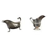 AN IRISH SILVER MILK JUG AND A SILVER SAUCEBOAT, the Irish jug is Dublin 1917, stamped with a