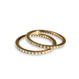 A PAIR OF DIAMOND SET ETERNITY RINGS each set with thirty nine four claw set diamonds.  Both rings