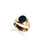 AN 18CT GOLD BLOODSTONE SIGNET RING with flat cut oval bloodstone and chased shoulders. Size Q.