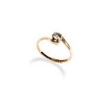 A SINGLE STONE DIAMOND RING of crossover design with a claw set brilliant-cut diamond. Ring size