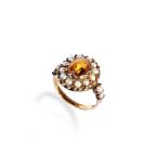 A SEED PEARL AND CITRINE RING the oval mixed-cut citrine claw set within a border of half cultured