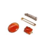 A COLLECTION OF ANTIQUE BROOCHES four in total, two carnelian stone brooches: a gold safety pin.