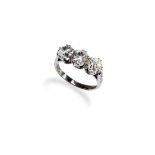 A THREE STONE DIAMOND RING the three old brilliant-cut diamonds claw set in white gold, between