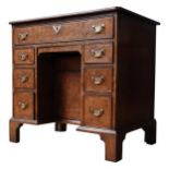 AN 18TH CENTURY STYLE BURR WALNUT KNEEHOLE DESK, with a quarter veneer inlaid top, a single frieze