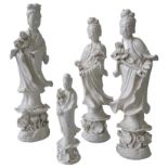 A PAIR OF CHINESE BLANC DE CHINE FIGURES OF GUANYIN, another larger example and a smaller example,