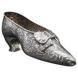 A VICTORIAN SILVER SHOE ORNAMENT, with floral repousse decoration, by Nathan & Haynes, Chester 1896,