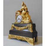 A 19TH CENTURY GILT & PATINATED BRONZE MANTEL CLOCK, in the Directoire style, with an engine