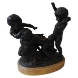 A LATE 19TH CENTURY BRONZE ON OVAL MARBLE PLINTH, depicting three putti in a harvest setting, the