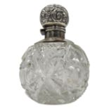 A CUT GLASS SPHERICAL SCENT BOTTLE, with silver repousse lid marked for Birmingham, 1903, 14cm