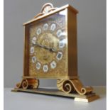 A SWISS IMHOF ORNATE BRASS MANTEL CLOCK, repousse decorated square dial with enamel Roman
