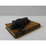 A NOVELTY RESIN FIGURE OF A BULL DOG, resting on a leather bound volume 'Alfred the Great', 6 x 18 x