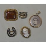 A COLLECTION OF BROOCHES A small Georgian brooch set with woven hair and a border of split pearls,