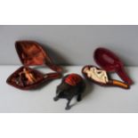 TWO VINTAGE MEERSCHAUM PIPES AND A PIN CUSHION, both pipes decorated with classical figurines, the