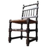 AN 18TH CENTURY OAK RUSH SEAT CHAIR, with a turned top rail, turned spindle back,. on four turned