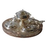 A SILVER PLATED LAZY SUSAN, with four oval vegetable serving dishes, a central soup tureen, sauce