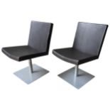 A PAIR OF LEATHER UPHOLSTERED CHAIRS, by European Design Ltd, central pedestal support on a square