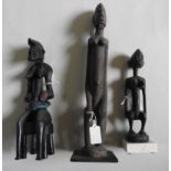 A CROUCHING FEMALE DOGON FIGURE, A KNEELING DOGON FIGURE AND A SENUFO SEATED FIGURE. 45 cms max