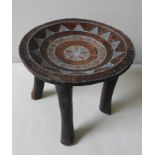 A VINTAGE KENYAN KAMBA CARVED WOOD STOOL WITH FOUR LEGS the top inset with beaded decoration, old