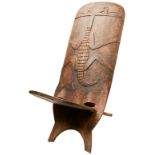 A AFRICAN PALAVER CHAIR of typical two-piece cantilever construction the rear carved with a