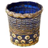 AN ANCIENT EGYPTIAN CORE-FORMED GLASS VESSEL of beaker shaped form, the cobalt blue body with raised