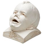 AN UNUSUAL PLASTER SCULPTURE OF A CHILDS HEAD OF CABALISTIC DESIGN the rear of the cranium with a