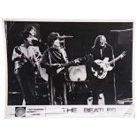 THE BEATLES: A TONY BARROW INTERNATIONAL BLACK AND WHITE PRESS PHOTOGRAPH OF THE BEATLES signed to