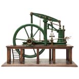 A MODEL OF A 19TH CENTURY BEAM PUMPING ENGINE with large five spoke flywheel mounted on an oak