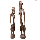 A WEST AFRICAN STANDING FIGURE AND ANOTHER SIMILAR 20th century.