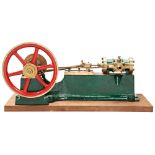 AN ENGINEERED MODEL OF A HORIZONTAL STEAM ENGINE on a cast iron base with brass flywheel and