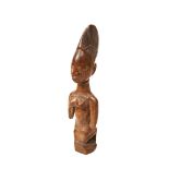 A YORUBA IBEJI FIGURE depicting a kneeling woman with old damages. 25 cms high PROVENANCE: The David