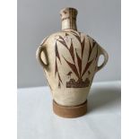 A PUEBLO POTTTERY VESSEL with three loop handles decorated with stylised birds and foliage with a