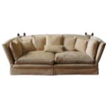 A LARGE THREE SEAT KNOLE SOFA, covered in a gold coloured brocade material, the sofa splits into two