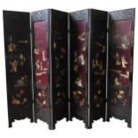 A CHINESE SIX-FOLD LACQUER SCREEN, the panels depiciting applied figures in a traditional rural