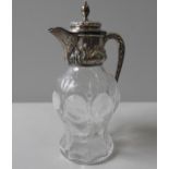 A SILVER MOUNTED CUT GLASS CLARET JUG, circa 1905, the silver collar, lid and spout with art nouveau