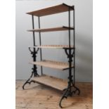 AN INDUSTRIAL STYLE FIVE TIER BOOKSHELF, comprised of a heavy duty cast-iron stand, and five