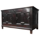 A CHARLES II OAK COFFER, of simplistic form, the moulded front panel bearing the initials I.E